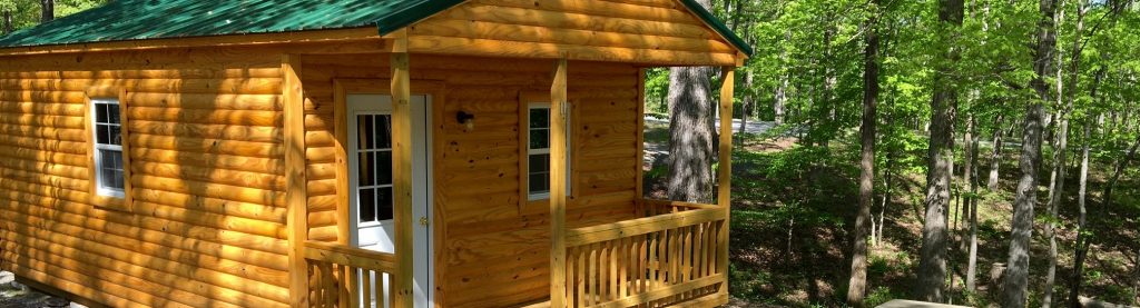 Wooden cabin with a porch among trees